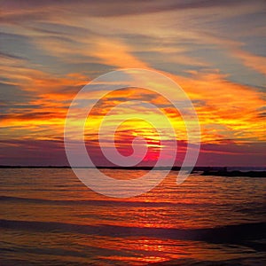 Light fiery sunset on the beautiful and bright ocean horizon