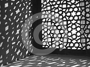 Light filtering through an elaborate latticework photo
