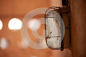 A light fixture with a metal frame and a glass shade