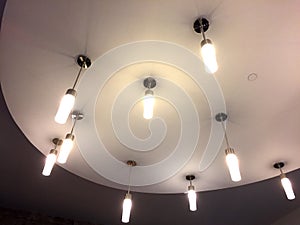 Light fixtures hang at ceiling of building