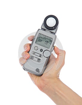 Light flash meter in hand isolated