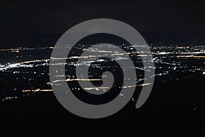 Light, flat area from a mountain height, dark sky.