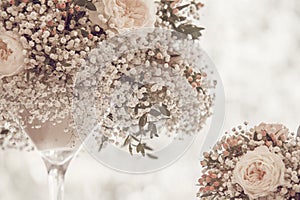 Light floral wedding decoration in elegant glass vase bleached colors