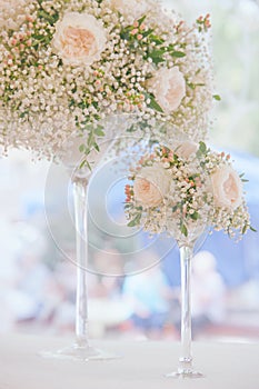 Light floral wedding decoration in two elegant glass vase bleached colors