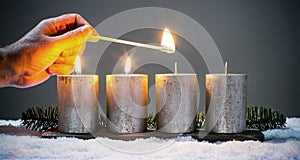 Light four advents candles with matches