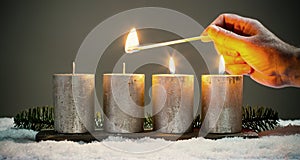 Light four advents candles with matches