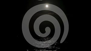 The light of the full moon is reflected in the sea water, the full moon in the sea