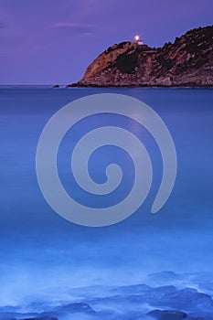 Light of Getaria lighthouse over the sea at night