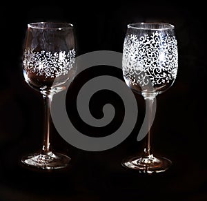 Light glass with beautiful silver pattern on a black background