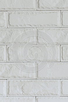 Light gray brick background. Old painted bricks wall. Vertical photo. Closeup