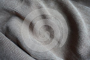 Light gray corduroy fabric in soft folds