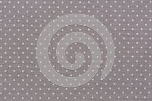 Light gray polka dot fabric texture background.