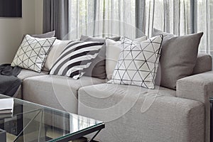 Light gray sofa with varies pattern pillows in livling corner