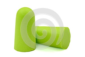 Light green ear plugs isolated on a white background.Close-up.Soft foam earplug