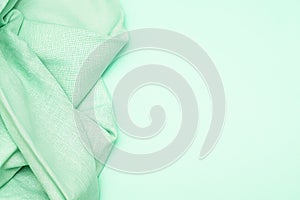 Light green fabric on green background with copy space. Light green fabric texture. Crumple light green fabric