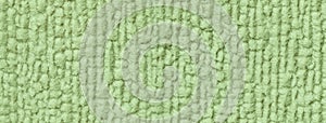 Light green fluffy background of soft, fleecy cloth. Texture of olive textile backdrop with pattern, macro