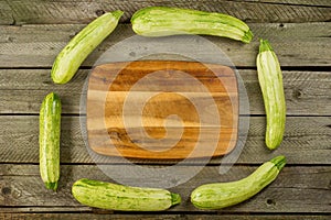 Light green fresh zucchini stacked, farm fresh produce, summer vegetables on rustic background. Top view