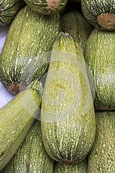 Light green fresh zucchini stacked in a heap shot from above, natural look on a market in Arequipa, Peru