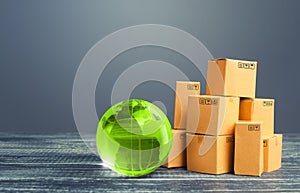 Light green globe and cardboard boxes. Economic relations commerce. Freight transportation. Global business, import, export.