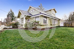 Light green house exterior with column porch