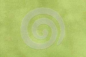 Light green matt suede fabric closeup. Velvet texture.