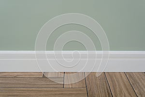 Light green matte wall, white baseboard