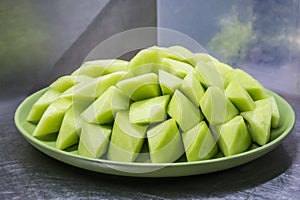 Light green melon on green plate