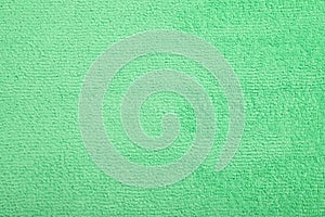 Light green microfiber cloth as background, top view