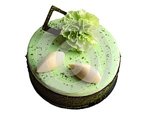 Light green pistachio lime round cake with chocolate border and fresh green carnation flower