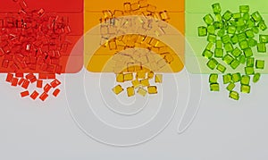 light green, red and orange transparent plastic granulates with samples