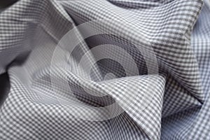 Light grey checkered fabric in soft folds