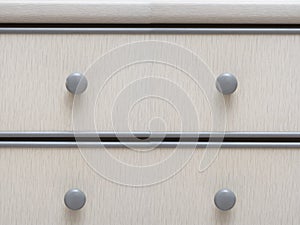 Light grey colored wooden cabinet drawers