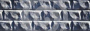 Light-grey decorative stone wall, made of regular shape bricks imitation, background, texture