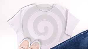 Light grey unisex t shirt mock up flat lay on white background. Top front view t-shirt, snikers, jeans and copy space. Mockup t-