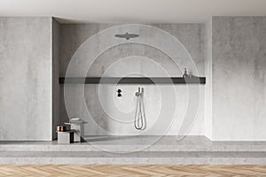 Light grey wooden bathroom with marble shower in wall on parquet floor