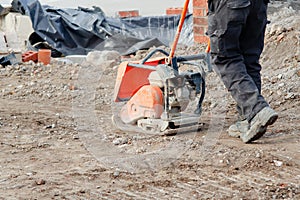 Light ground compactor used by groundworker on construction site