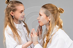 Light-haired beaming girls playing together in studio