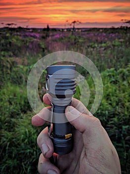 The light of a hand flashlight turns into sunset photo