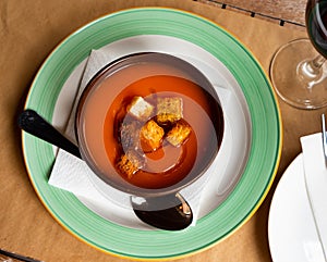 Light healthy carrot cream soup with croutons served in plate