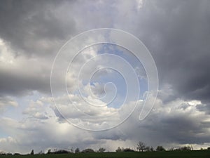 Light from heaven, blue planet Earth in white clouds, bright sunlight from above