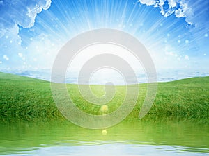 Light from heaven, bright sunlight with reflection in water, green grass on meadow