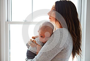 The light of her life. a mother holding her newborn baby.