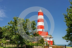 Light House on the sea shore in summer time with blue sky