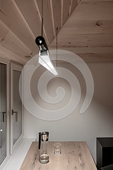 Light illuminated interior with sloping wooden ceiling