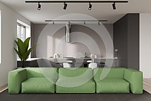 Light kitchen interior with couch and table with chairs, chill area and window