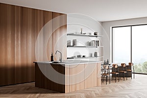 Light kitchen interior with countertop and seats, kitchenware and panoramic window