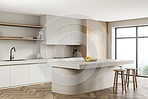 Light kitchen interior with table and chairs near window on parquet floor