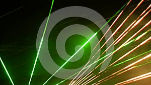 Light laser show on a black background of the night sky, outdoor performance. Multi-colored laser beams turn into