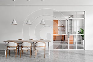 Light living room interior with table and seats, glass doors and kitchen room