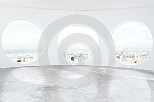 Light loft room with round windows and concrete floor